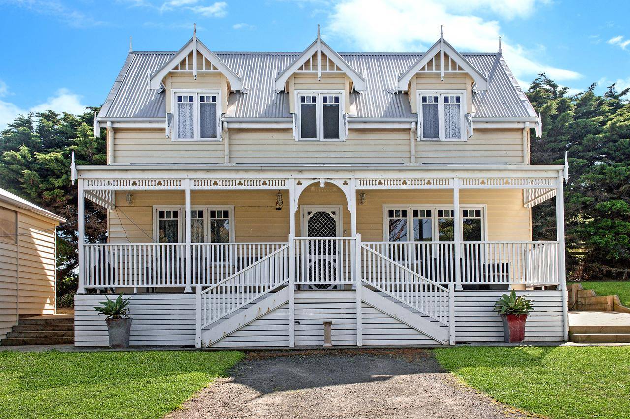 Dunes Double Storey Villa: cream two-storey coastal villa with gabled roof and white verandah, Port Fairy