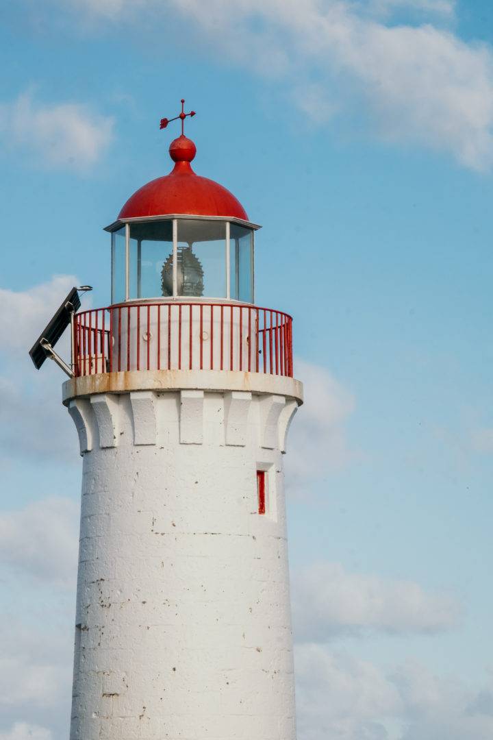 Port Fairy's Griffiths Island lighthouse against a blue sky