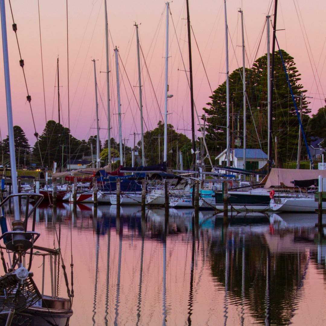 Yachts moored in Port Fairy marina at dusk