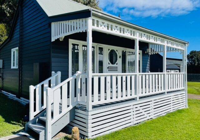 Nest Classic Villa: navy cottage with white verandah, steps and balustrade