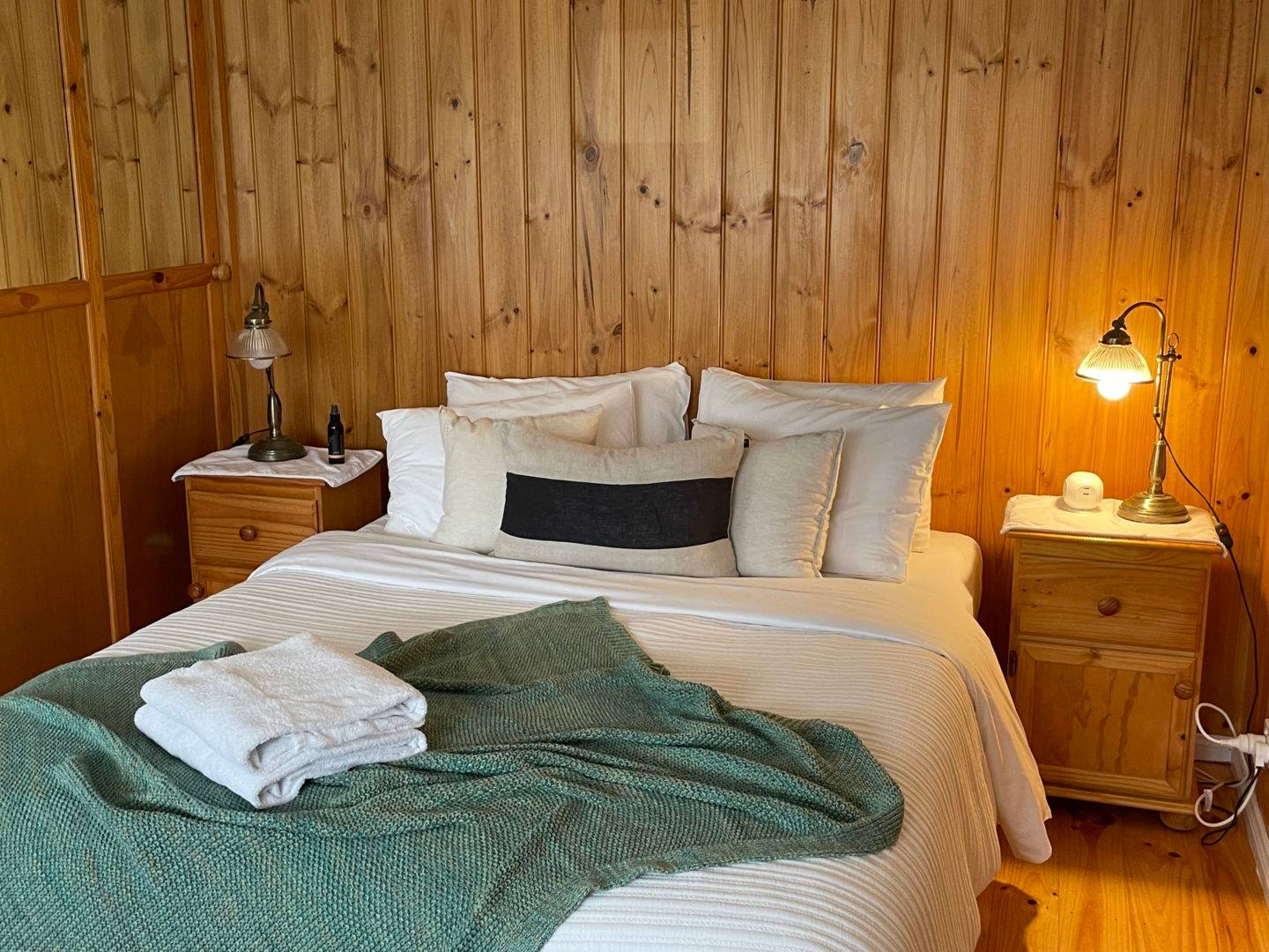 Nest villa queen bedroom with timber-panelled walls