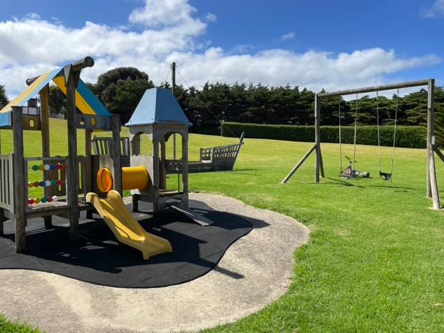 Children's playground with slide and swings in the gardens
