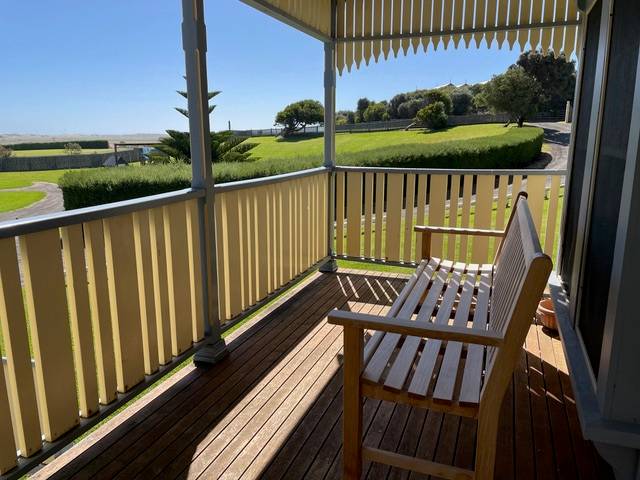 Sails villa upstairs verandah with outdoor seating overlooking the gardens