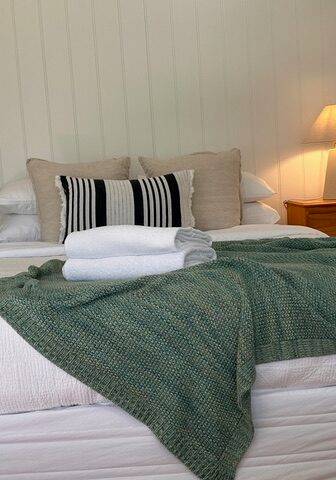 Sandpiper villa queen bedroom with green throw